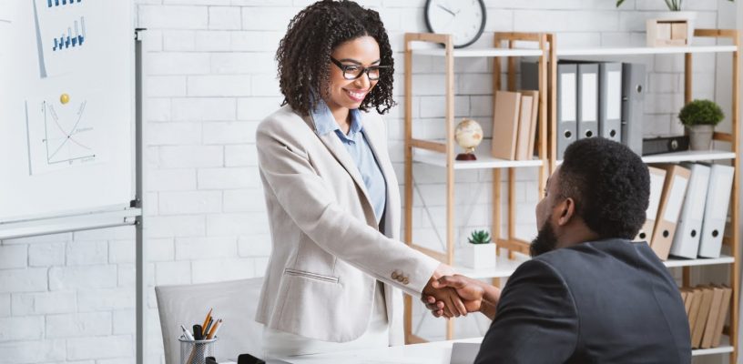 black-hiring-manager-shaking-hands-with-successful-CMKXBW6